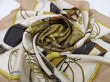 beige and brown scarf with a picture of a horse and rider on it