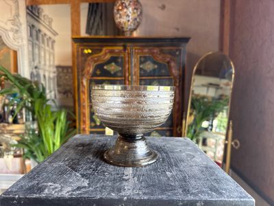 a glass bowl sitting on top of a wooden table
