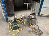 a machine that is sitting on the ground in front of a building