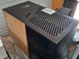 a black microwave sitting on top of a wooden cabinet
