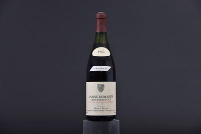 a bottle of wine sitting on top of a wooden table