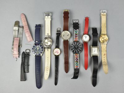 several different types of watches are lined up on a gray surface
