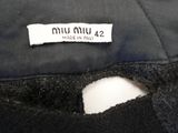 the label on the back of a black dress with a white background
