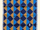 a blue, yellow and orange square scarf with a white border
