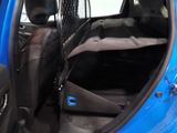 a blue car with its back door open and a seat in the back of it