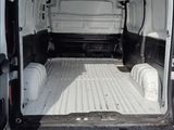 a white van that is parked in the dirt