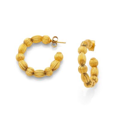 a close up of a pair of gold hoop earrings on a white background