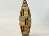 a small vase that is sitting on a white surface