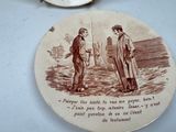 a plate with a picture of two men standing next to each other