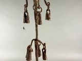 a picture of a metal pole with bells attached to it