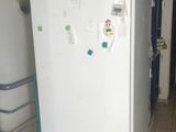 an image of a refrigerator in a kitchen with papers all over it