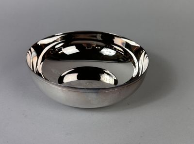 a silver bowl that is sitting on a table