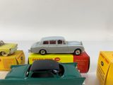 several toy cars are lined up in a row on a white surface