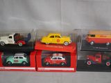 four different models of cars in boxes on a table