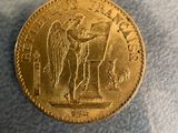 a close up of a gold coin with an angel on it