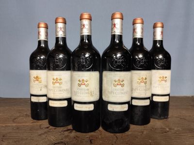 six bottles of wine sitting on top of a wooden table
