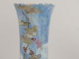a blue vase with gold and red designs on it