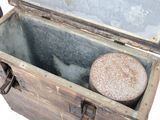 an old wooden chest with a stone inside of it