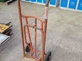 a hand truck that is sitting on the concrete floor