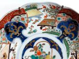 a decorative plate with a basket of fruit on it