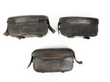 three pieces of old leather are shown on a white surface
