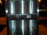 an image of a stainless steel oven on a wooden table