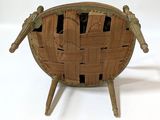 a wooden chair that has a woven seat on it