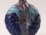 a blue and purple vase sitting on a white surface