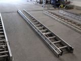 a large metal conveyor belt in the middle of a building