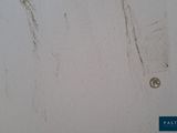 a picture of a dirty wall with some stains on it