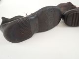 pair of brown leather shoes on a white surface with a white background
