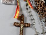 many rosary beads and a wooden cross on a table