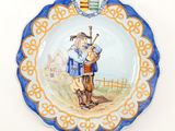 a plate with a picture of a man and a dog on it