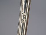 a close up of a silver spoon on a table