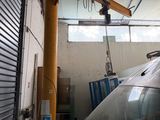 a car that is parked in a garage with a crane on top of it