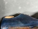 a pair of blue shoes that are on a shelf
