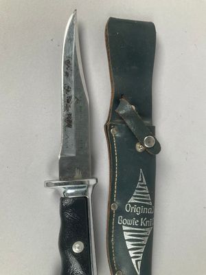an image of a knife and sheath on a white surface