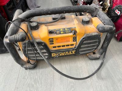a yellow and black portable air compressor sitting on the ground