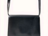 an image of a black purse on a white background