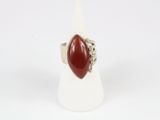 a close up of a ring with a red stone in it