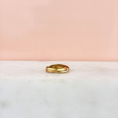 a gold ring sitting on top of a marble counter