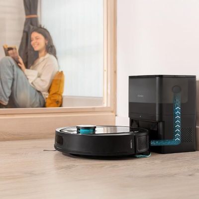 a robot that is sitting on the floor in front of a mirror