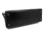 a black leather purse with gold hardware on the front