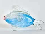 a glass fish that is sitting on a table