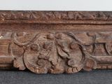 a close up of a carved wood frame on a table