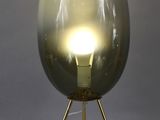 a gold glass table lamp with a tripod base and a gold metal base
