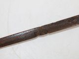an old rusty knife that is laying on a table