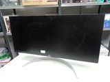 a computer monitor sitting on a desk in a store
