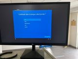 a computer monitor sitting on a desk in an office