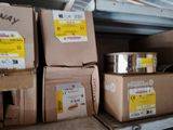 many boxes that are stacked on a shelf in a room